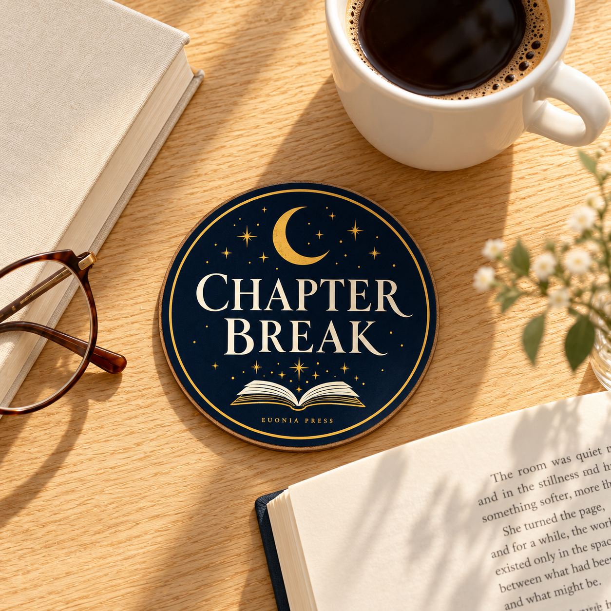 Chapter Break Coaster styled on a reading desk with coffee and books