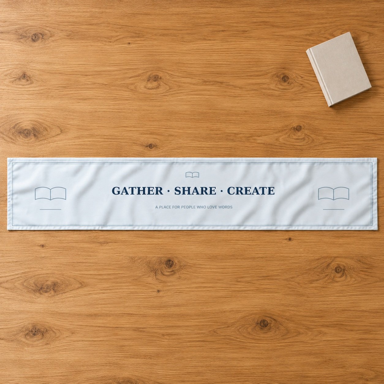 Gather Share Create author table runner with navy wording, book motifs and blue borders on a pale-blue front.