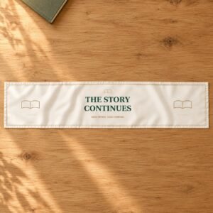 The Story Continues author table runner with forest-green words, book outlines and a fine gold-coloured printed border on ivory.